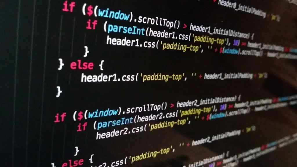 Web developer writing HTML code on a computer, including alt text attributes